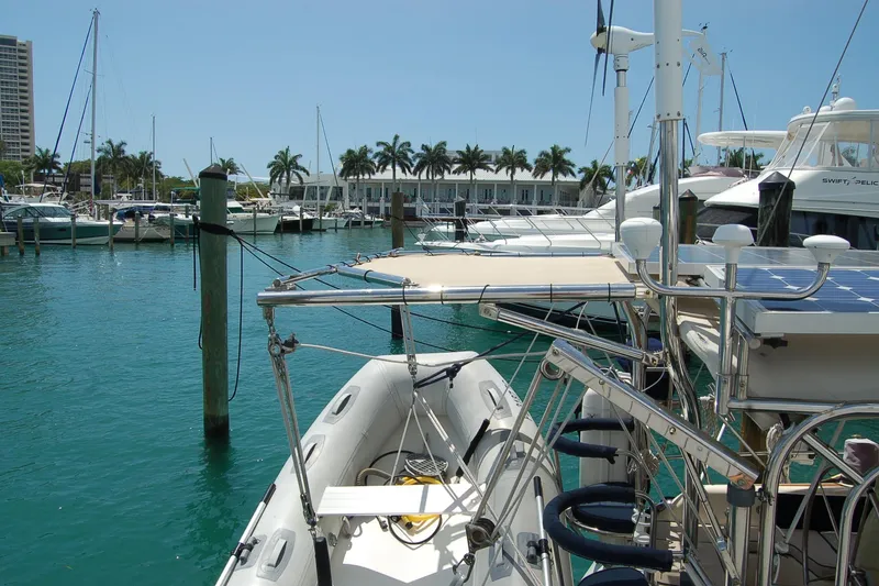 Slide: The Image of Docked Caliber 40 LRC SE sailboat in a marina, surrounded by clear blue water. - 28