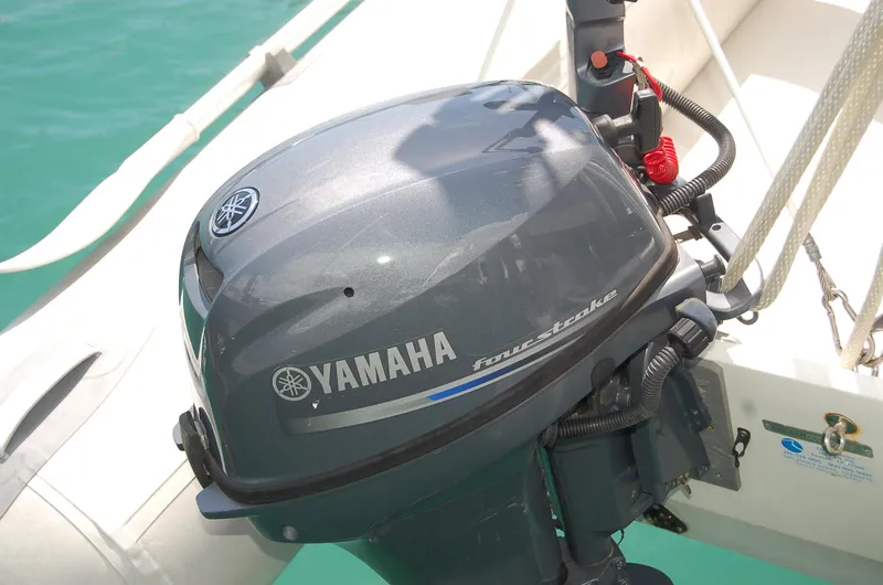 Slide: The Image of Yamaha outboard motor on a 2005 Caliber 40 LRC SE sailboat, docked in clear water. - 29
