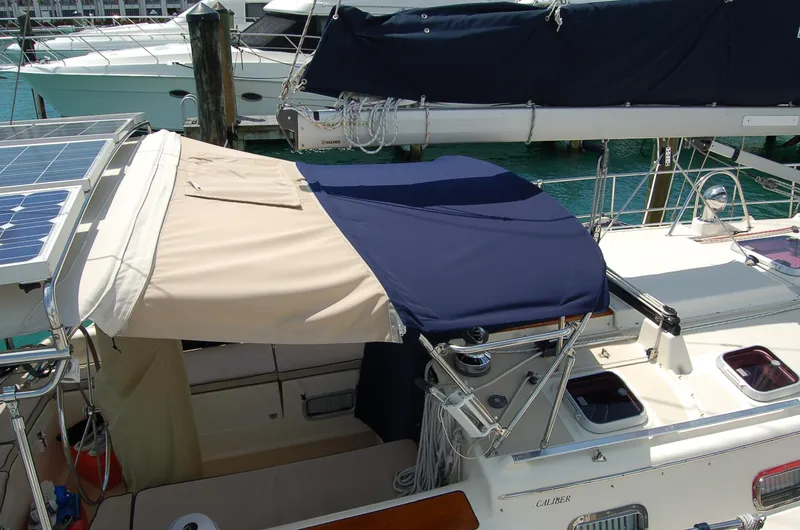 Slide: The Image of Sailboat Caliber 40 LRC SE 2005 with blue and beige canopy, docked in marina. - 33