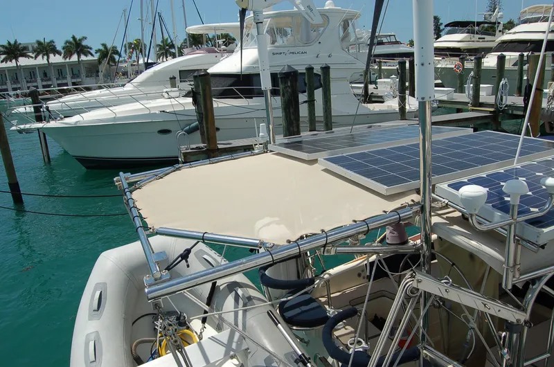Slide: The Image of 2005 Caliber 40 LRC SE yacht with solar panels docked at a marina. - 35