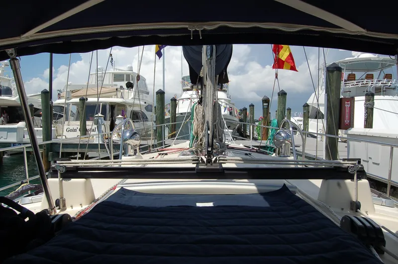 Slide: The Image of 2005 Caliber 40 LRC SE sailboat docked at marina with flags and other boats. - 39