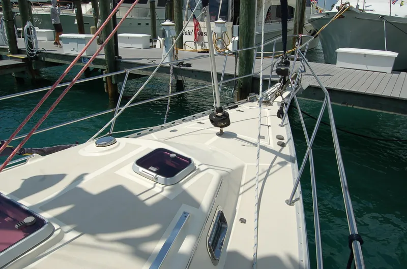 Slide: The Image of 2005 Caliber 40 LRC SE sailboat deck at marina, featuring rigging and hatches. - 9