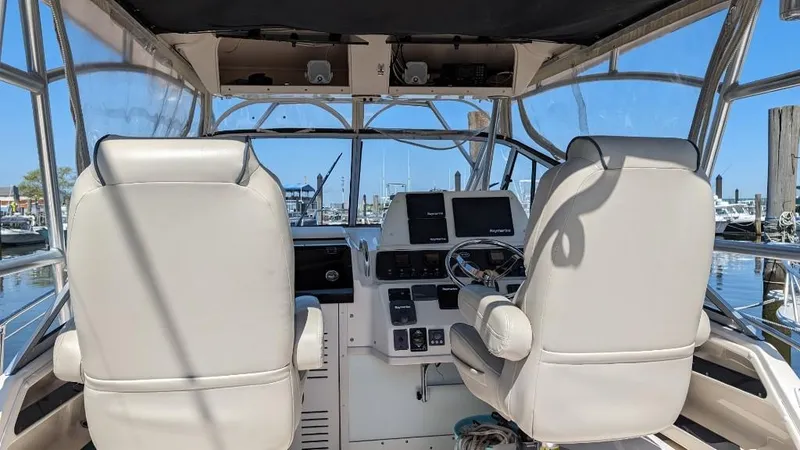 Slide: The Image of 2006 Grady-White Marlin 300 boat cockpit with dual seats and navigation equipment. - 8