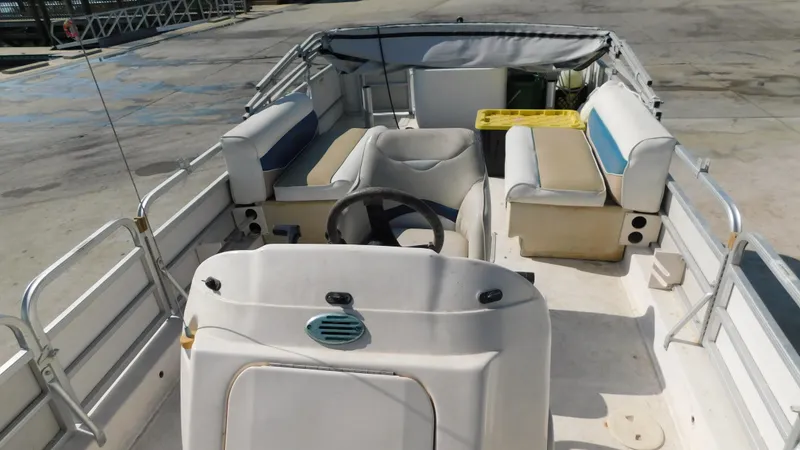 Slide: The Image of 2006 Hurricane 22 Deck Boat interior with seating and steering wheel. - 13