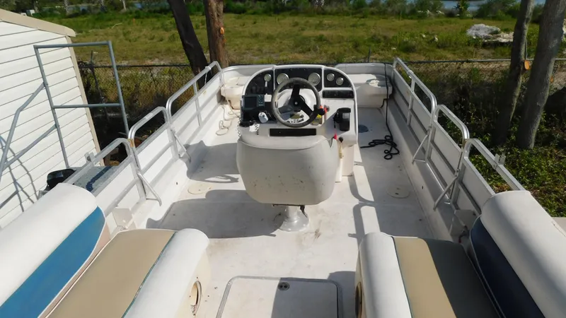 Slide: The Image of 2006 Hurricane 22 Deck Boat interior with seating and steering console. - 16