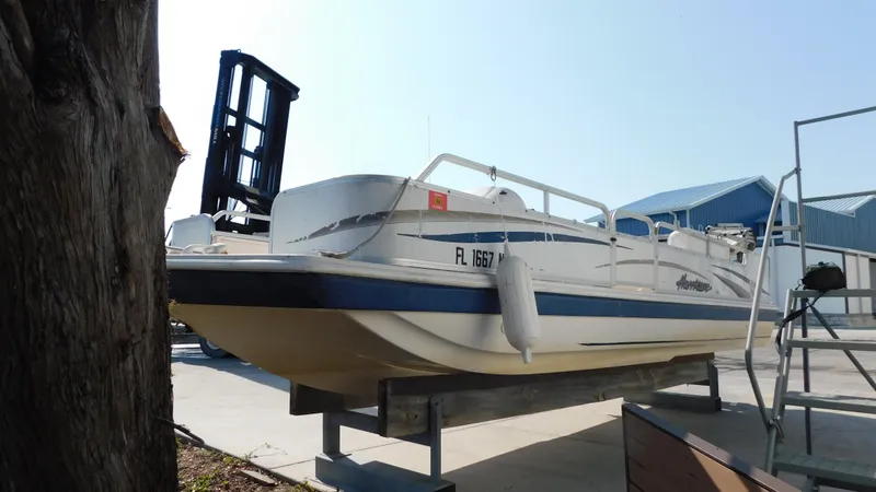 Slide: The Image of 2006 Hurricane 22 Deck Boat on a lift at a marina. - 4