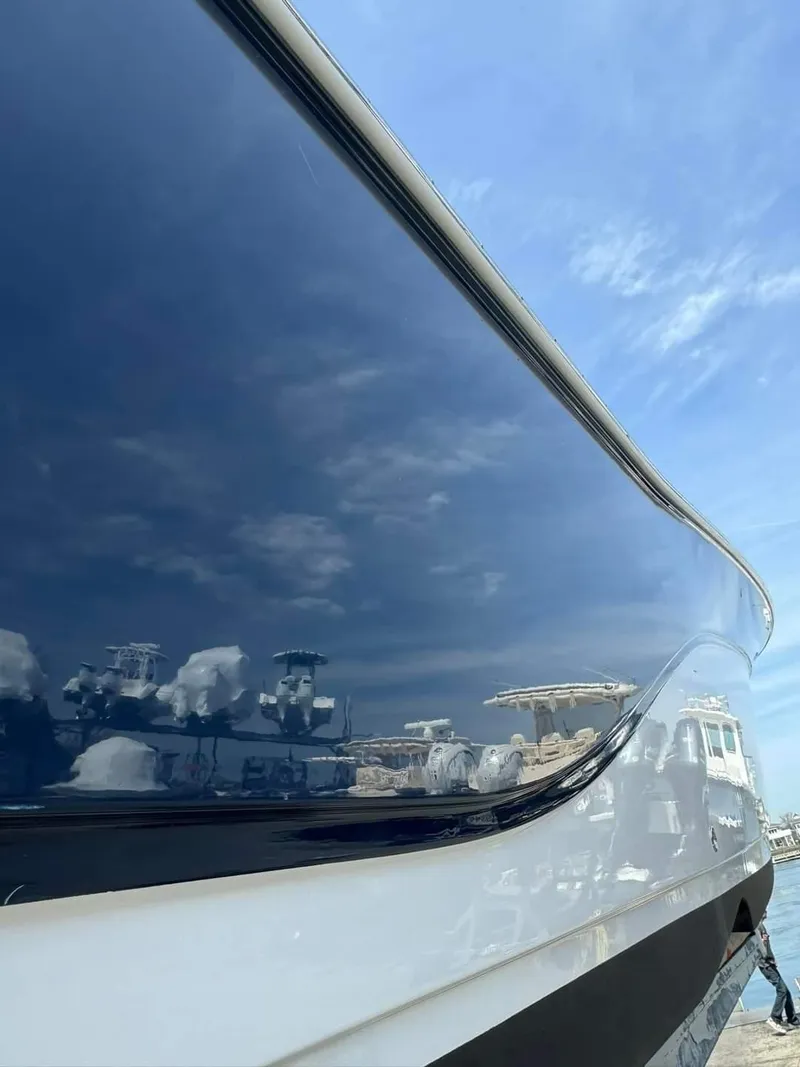 Slide: The Image of 2020 Sea Fox 328 Commander boat hull reflecting sky and marina. - 15