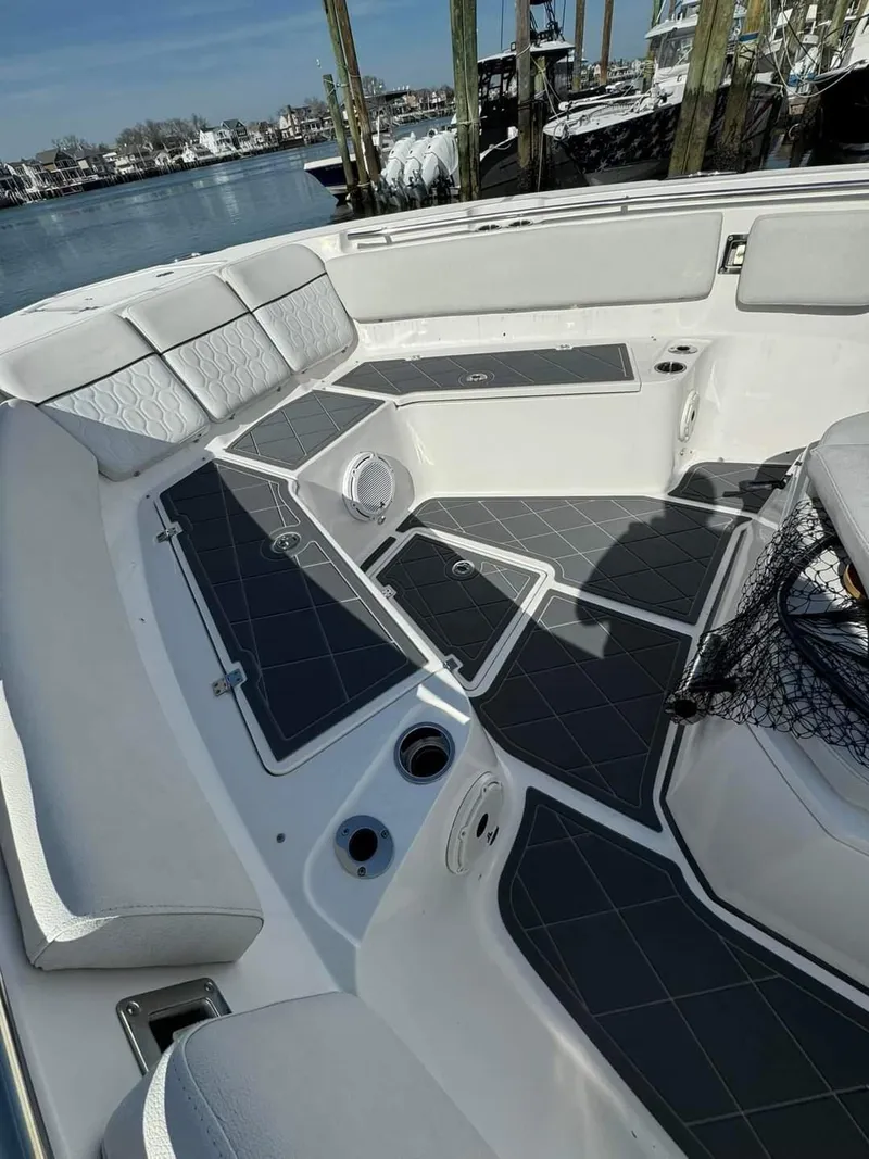 Slide: The Image of 2020 Sea Fox 328 Commander boat interior with cushioned seating and waterfront view. - 17