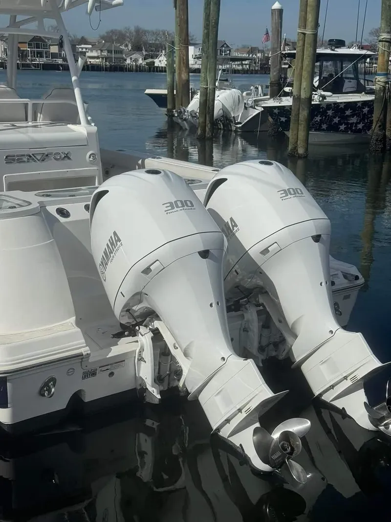 Slide: The Image of 2020 Sea Fox 328 Commander with twin Yamaha 300 outboard engines docked in a marina. - 3