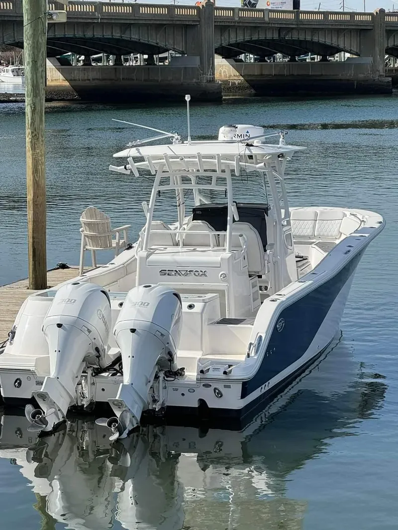 Slide: The Image of 2020 Sea Fox 328 Commander boat docked with twin outboard engines. - 7