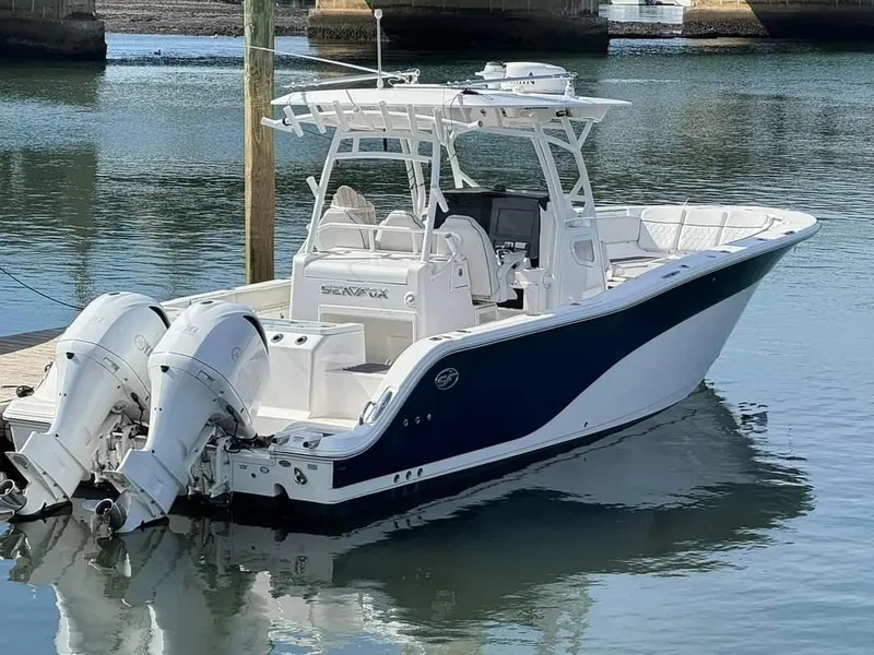 Slide: The Image of 2020 Sea Fox 328 Commander boat docked with twin outboard engines. - 8