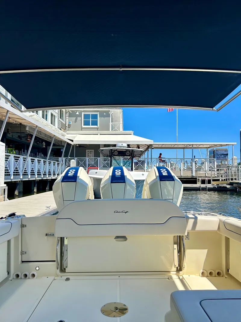 Slide: The Image of 2023 Chris-Craft 35 CALYPSO boat docked with triple outboard engines. - 17