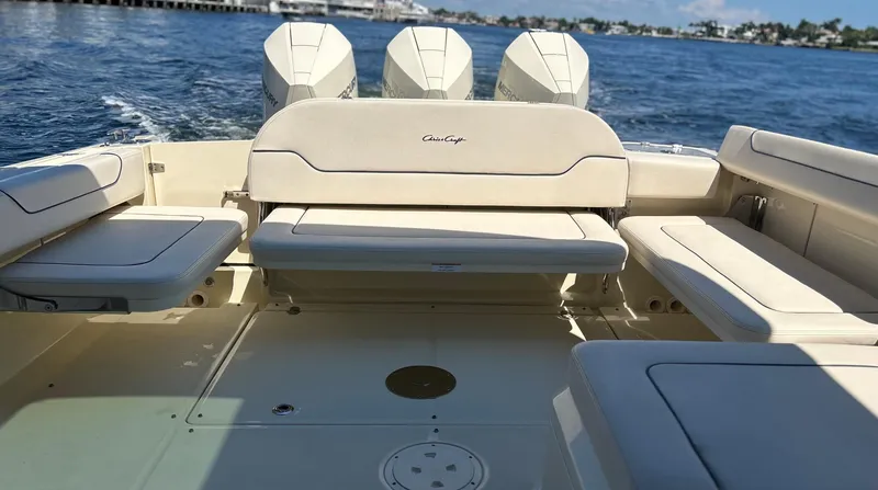 Slide: The Image of 2023 Chris-Craft 35 CALYPSO boat with beige seating and triple outboard engines on the water. - 8