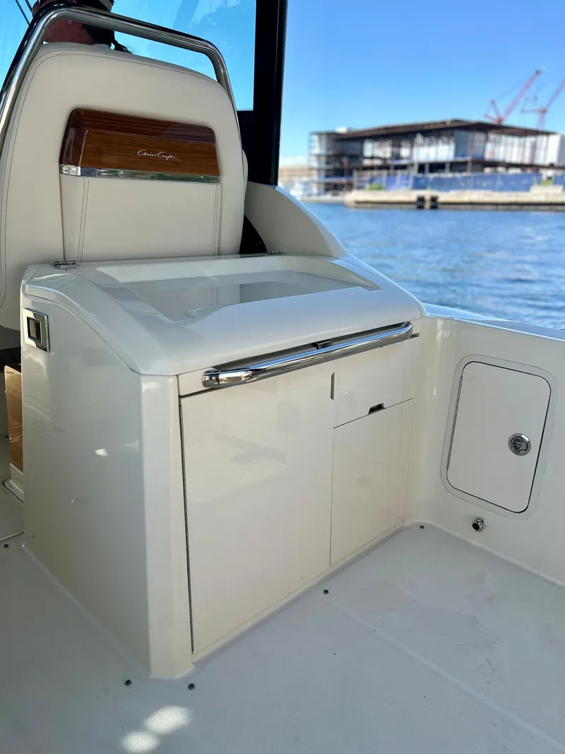 Slide: The Image of 2023 Chris-Craft 35 CALYPSO boat interior with storage compartments and water view. - 9
