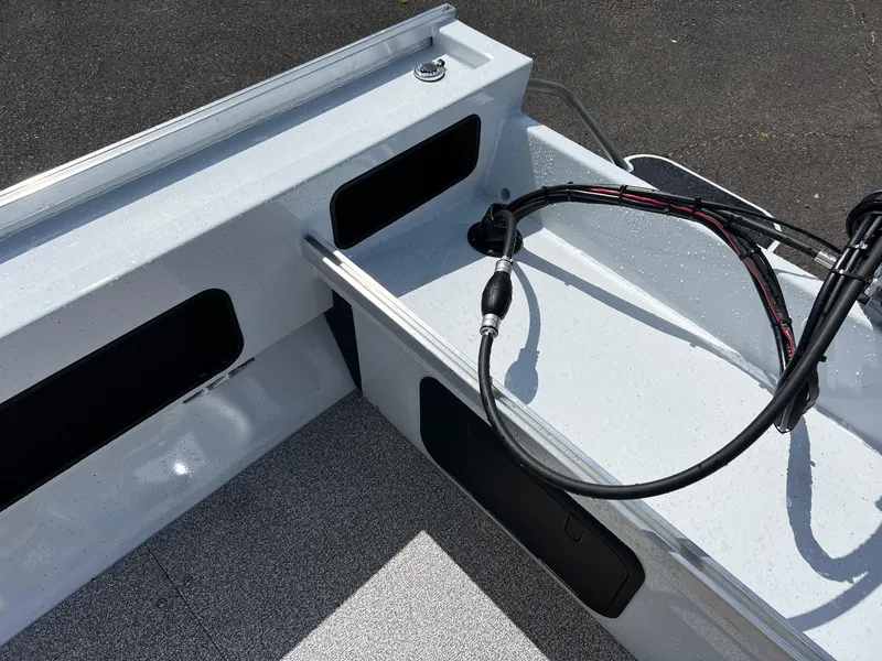Slide: The Image of 2024 Fish Rite Angler 18 boat interior with diamond plate and storage hatch. - 11