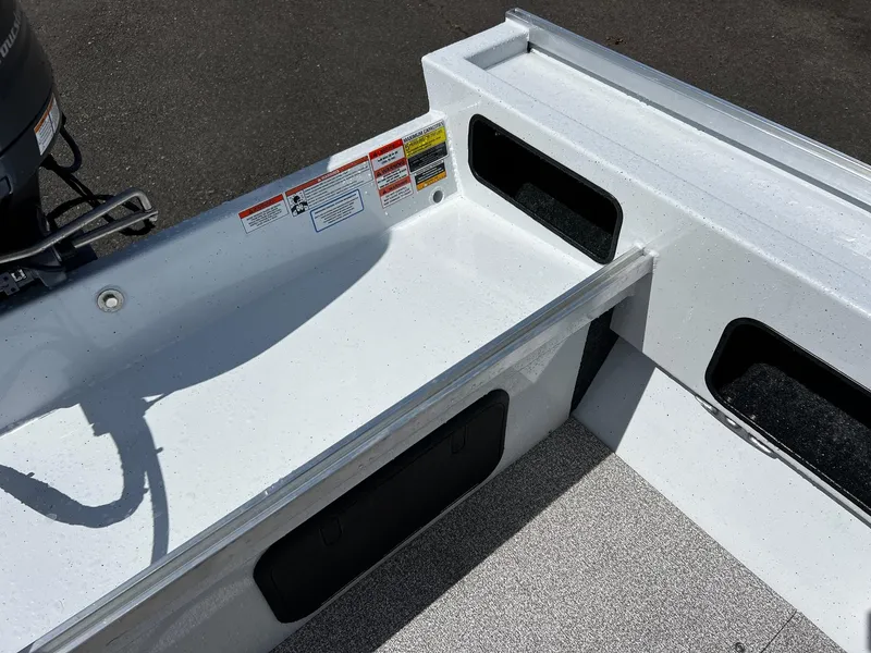 Slide: The Image of 2024 Fish Rite Angler 18 boat interior with two cushioned seats and storage compartments. - 12