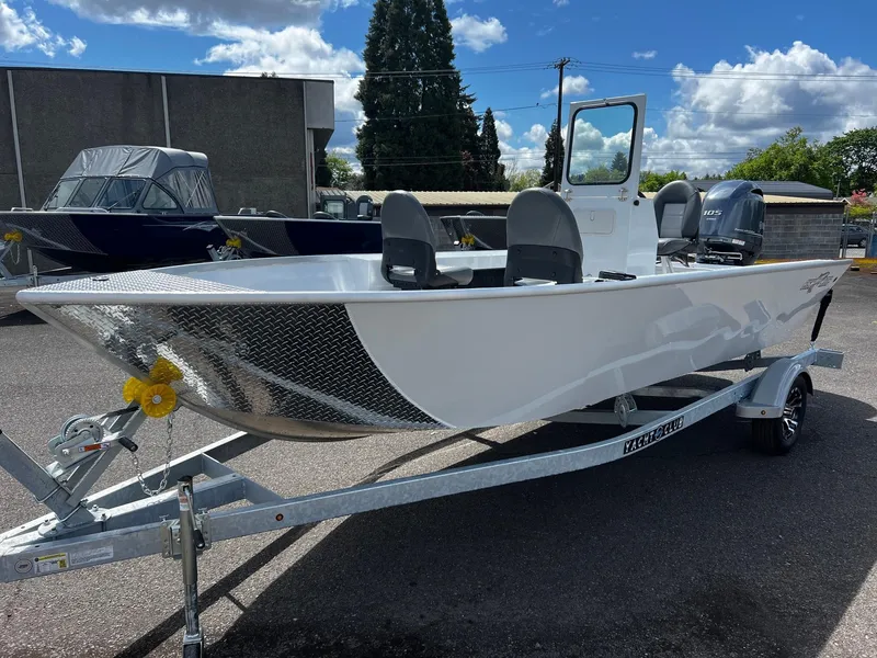 Slide: The Image of 2024 Fish Rite Angler 18 boat on trailer, parked outdoors in a sunny setting. - 4