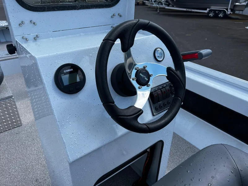 Slide: The Image of 2024 Fish Rite Angler 18 boat console with steering wheel and gauge. - 6