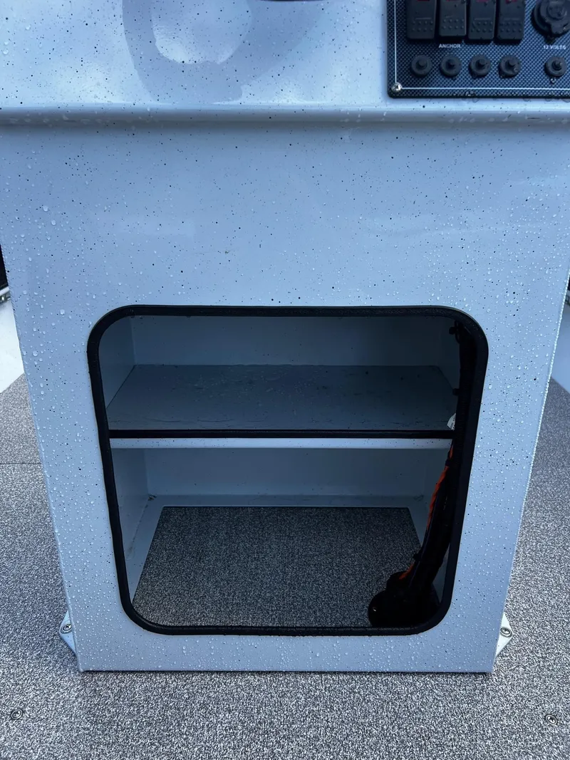 Slide: The Image of 2024 Fish Rite Angler 18 boat console with controls and windshield. - 9