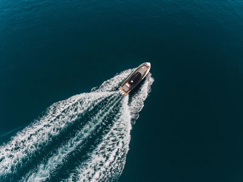 Slide: The Image of Aerial view of Custom 44S boat cruising on open water, 2025 model. - 6