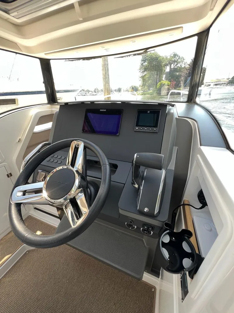 Slide: The Image of 2023 Nimbus C9 boat cockpit with modern steering wheel and navigation screens. - 11