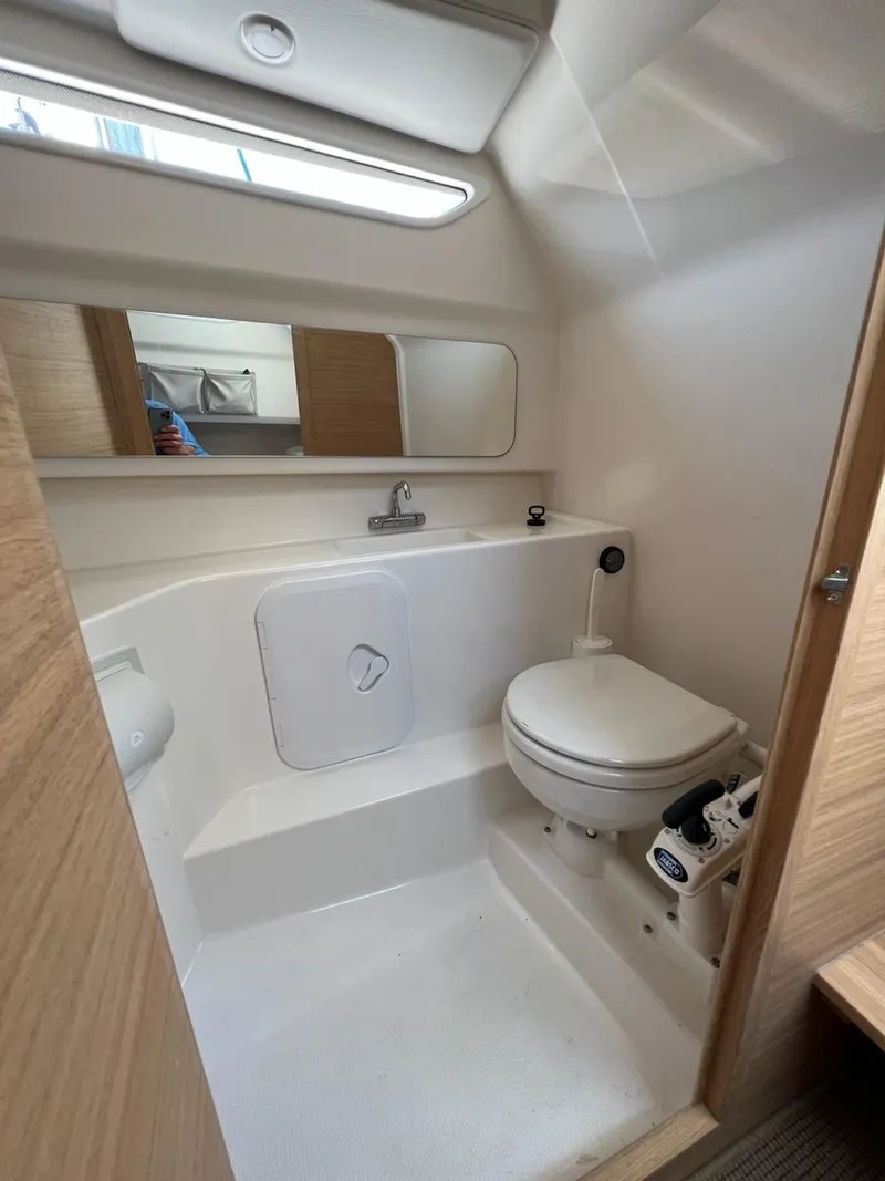 Slide: The Image of Modern bathroom in 2023 Nimbus C9 boat with toilet, sink, and mirror. - 13