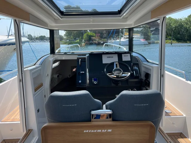 Slide: The Image of Interior of 2023 Nimbus C9 boat with modern cockpit and waterfront view. - 16