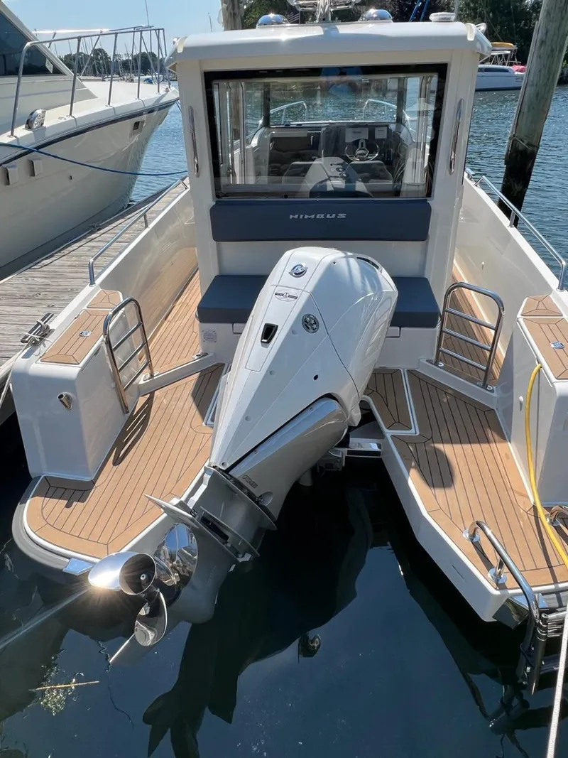 Slide: The Image of Nimbus C9 2023 model boat with outboard motor docked at marina. - 19