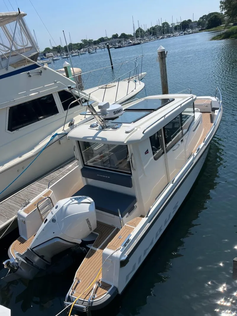 Slide: The Image of 2023 Nimbus C9 boat docked at a marina. - 20