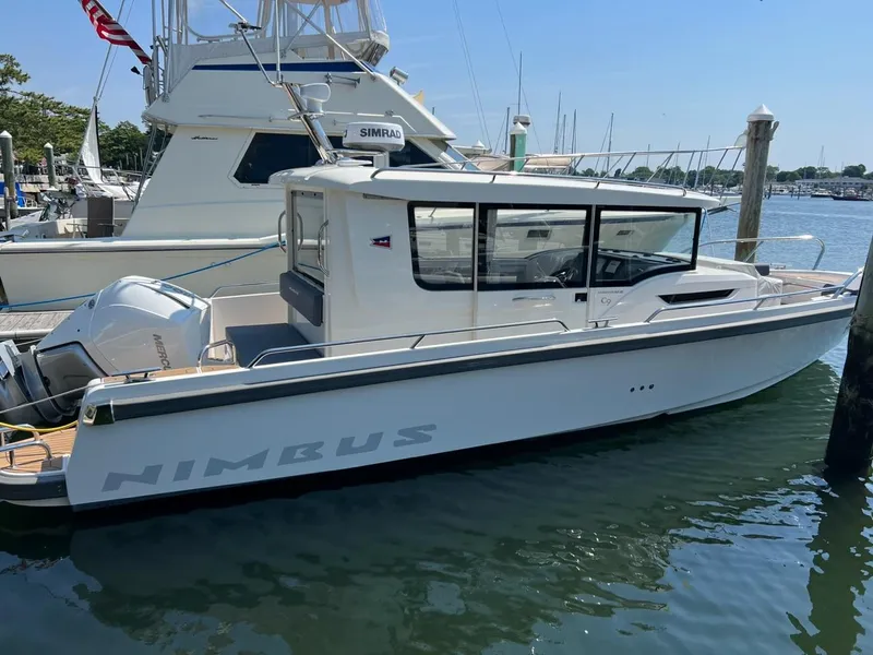 Slide: The Image of 2023 Nimbus C9 boat docked at marina. - 21