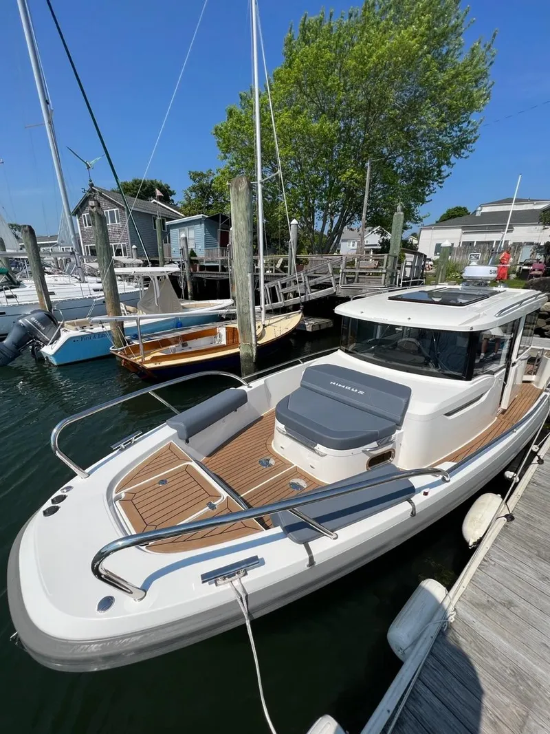 Slide: The Image of 2023 Nimbus C9 boat docked at a marina on a sunny day. - 3