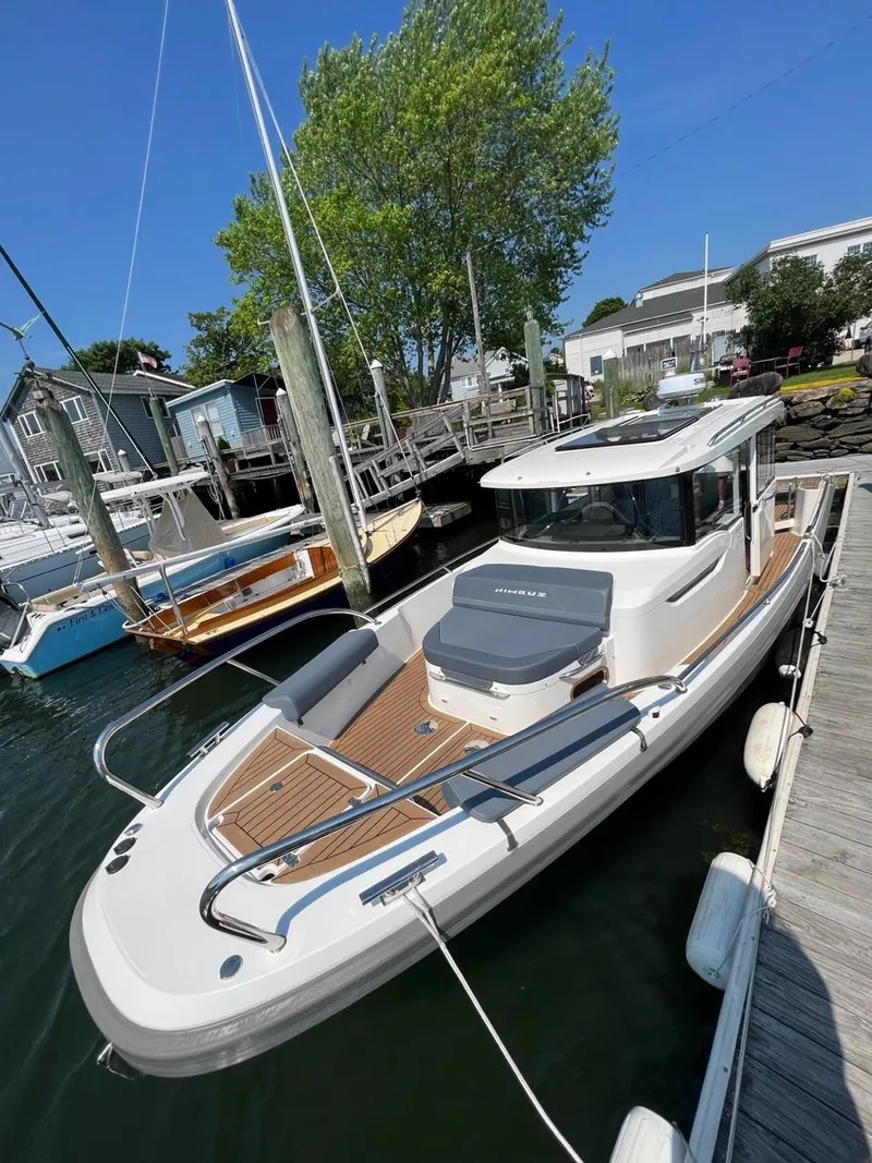 Slide: The Image of 2023 Nimbus C9 boat docked at a marina on a sunny day. - 4