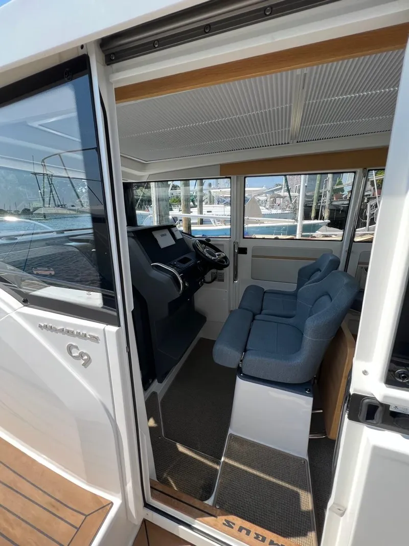 Slide: The Image of Interior of 2023 Nimbus C9 boat with modern cockpit and blue seating. - 5