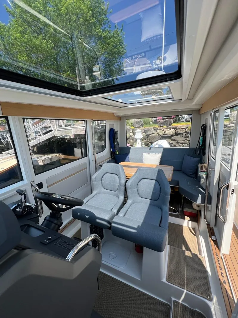 Slide: The Image of Interior of 2023 Nimbus C9 boat with modern seating and panoramic windows. - 7
