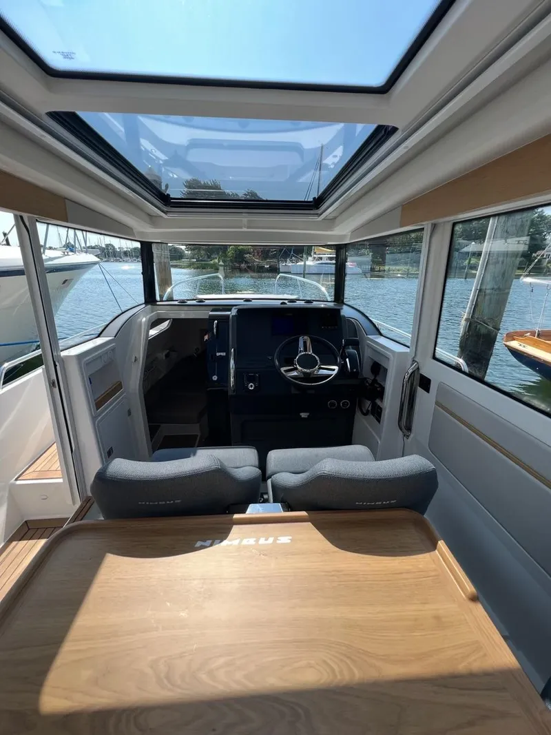 Slide: The Image of Interior of 2023 Nimbus C9 boat with modern helm and panoramic windows. - 8