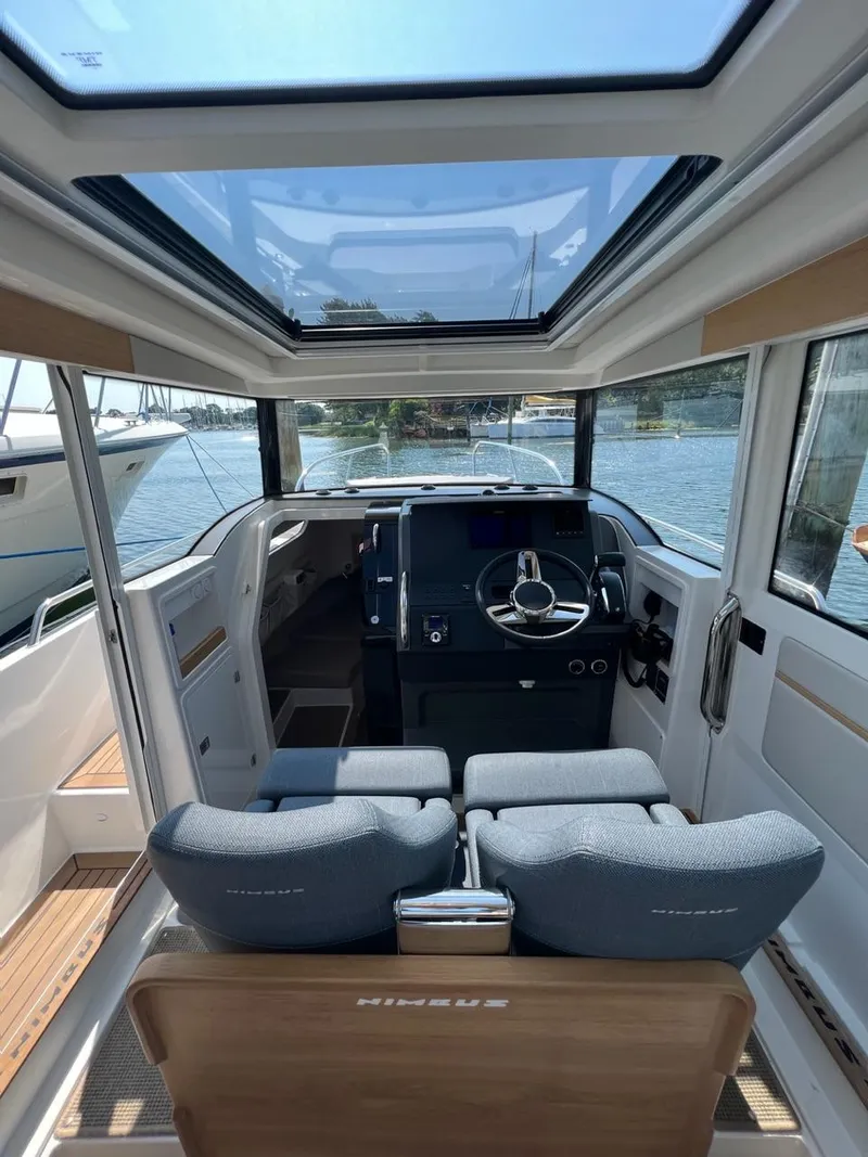 Slide: The Image of Interior of 2023 Nimbus C9 boat with modern helm and panoramic sunroof. - 9