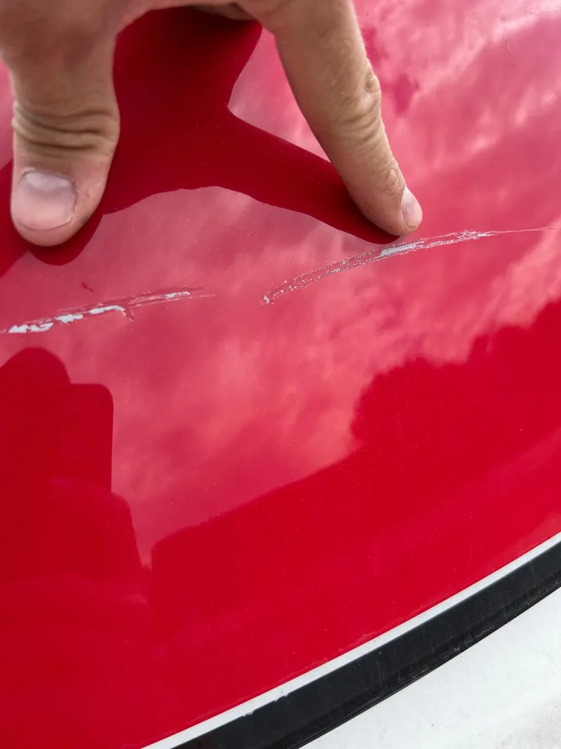 Slide: The Image of Close-up of a scratch on a 2007 Formula 310SS boat's red surface. - 18