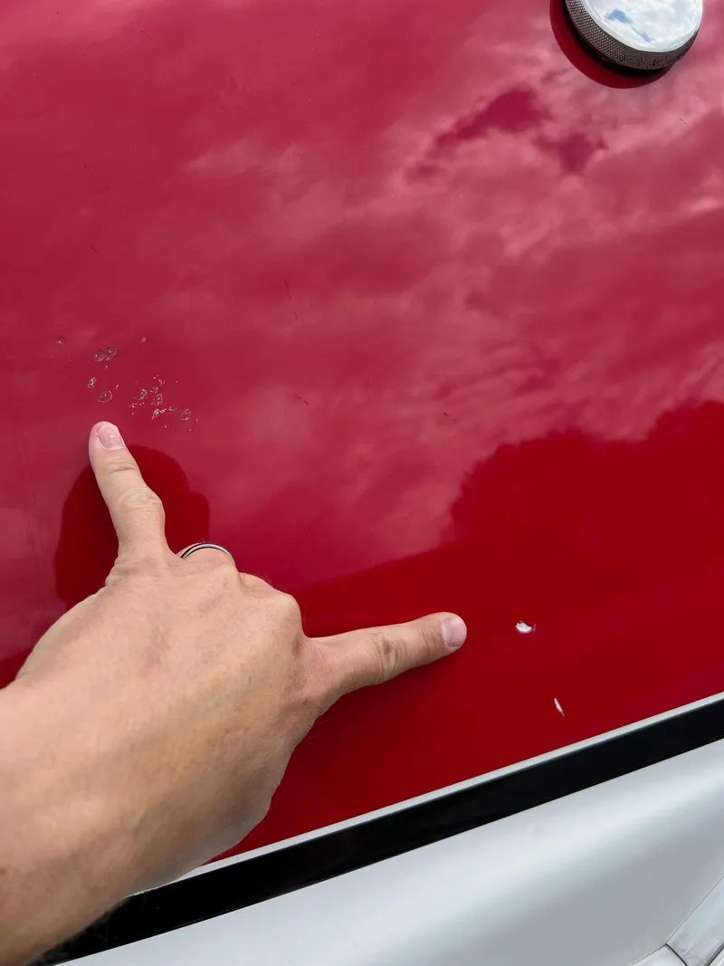 Slide: The Image of Close-up of a 2007 Formula 310SS boat with minor paint damage. - 19