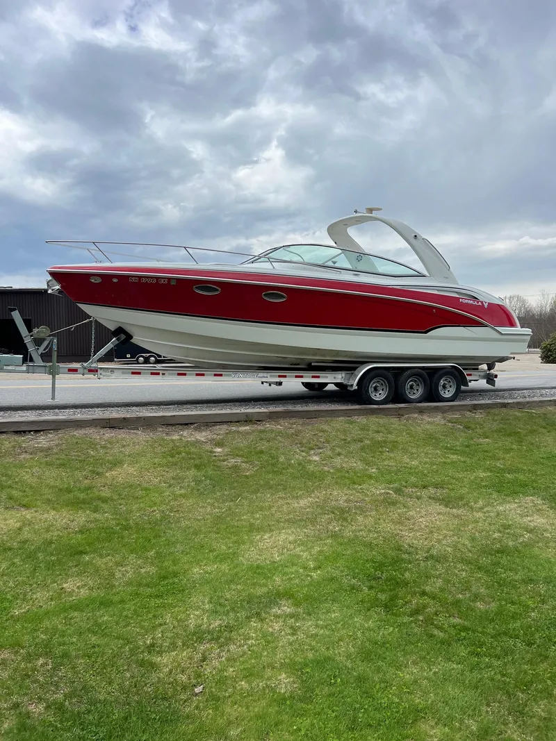 Slide: The Image of 2007 Formula 310SS boat on a trailer, red and white exterior. - 2