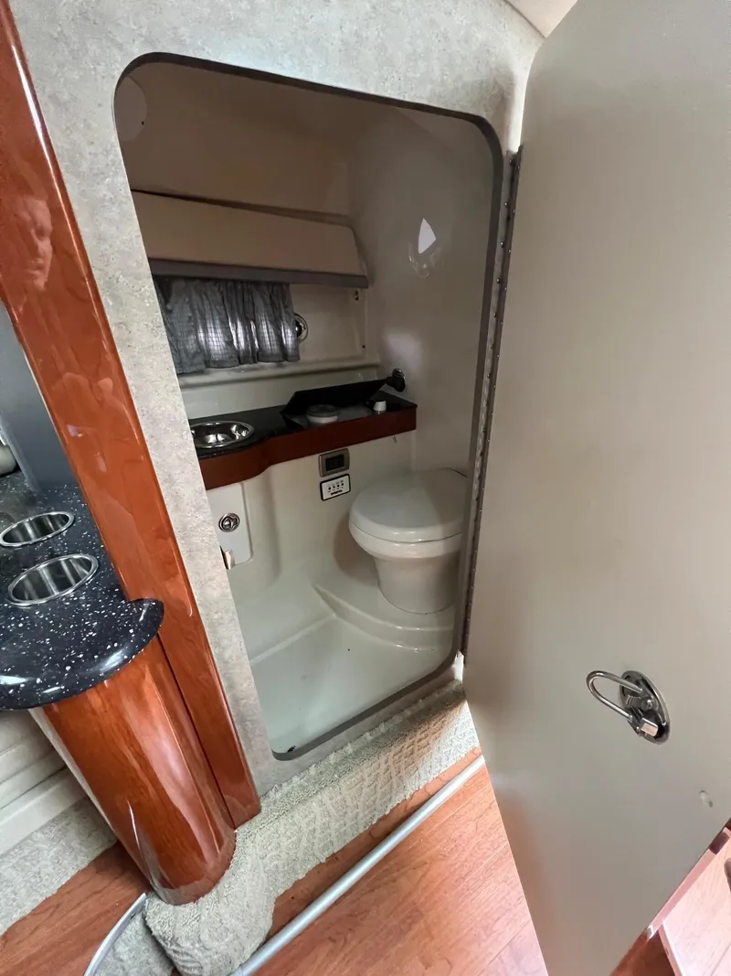 Slide: The Image of 2007 Formula 310SS boat interior bathroom with toilet and sink. - 5