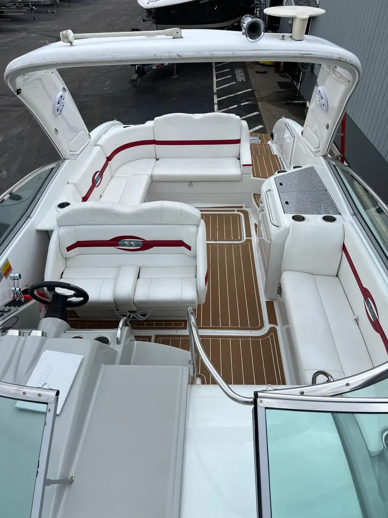 Slide: The Image of 2007 Formula 310SS boat with white and red interior, spacious seating, and wooden flooring. - 9