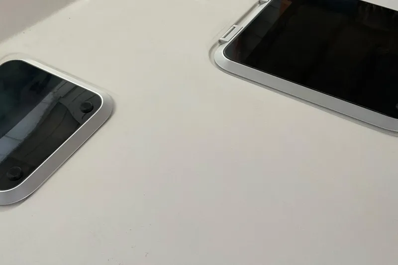 Slide: The Image of 1999 Pursuit Offshore Express boat hatches on deck, featuring sleek design and durable construction. - 10