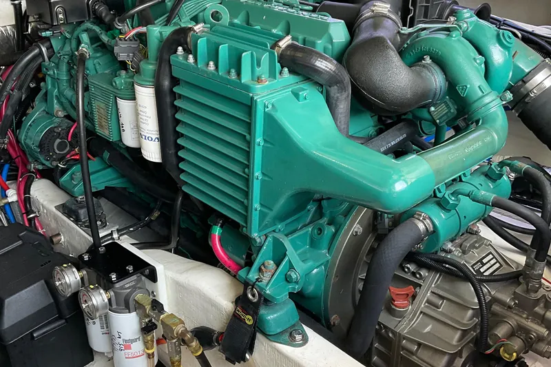 Slide: The Image of Engine of a 1999 Pursuit Offshore Express boat, showcasing intricate mechanical components. - 12