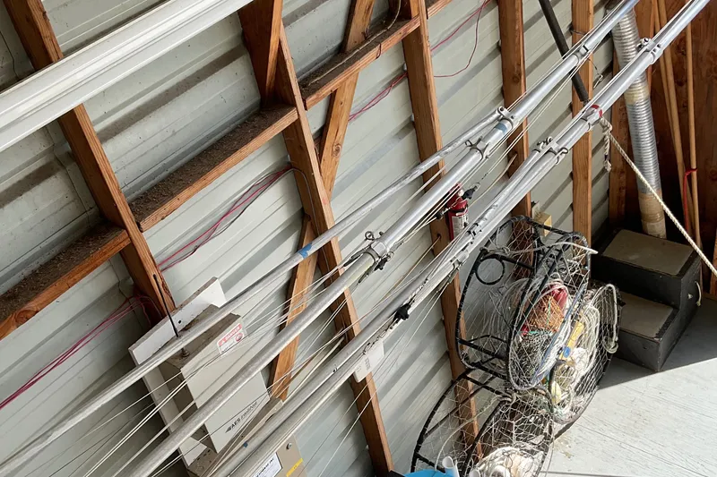 Slide: The Image of Fishing rods and gear stored in a wooden shed, Pursuit OFFSHORE EXPRESS 1999. - 28