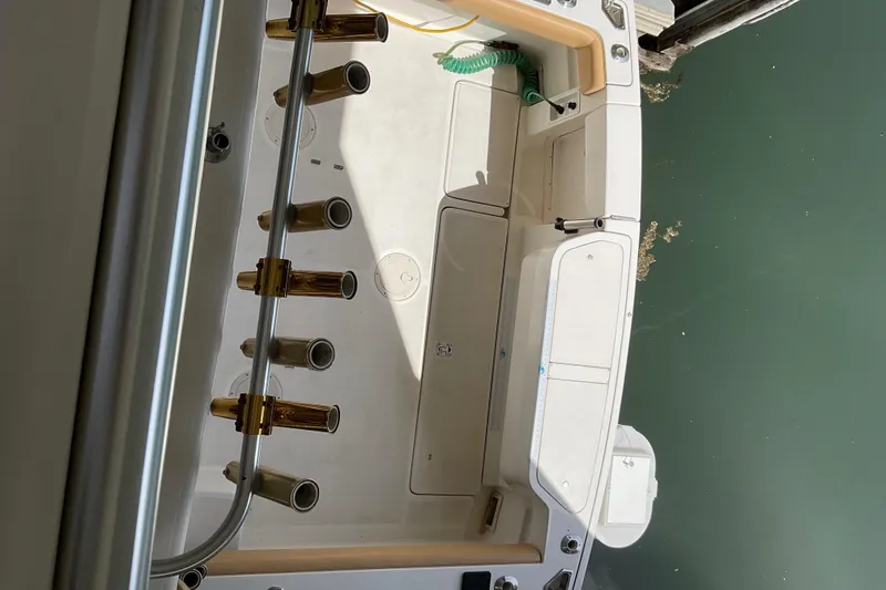 Slide: The Image of 1999 Pursuit OFFSHORE EXPRESS boat deck with rod holders, viewed from above. - 30