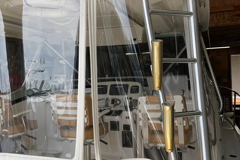 Slide: The Image of 1999 Pursuit Offshore Express boat interior with helm and seating. - 31