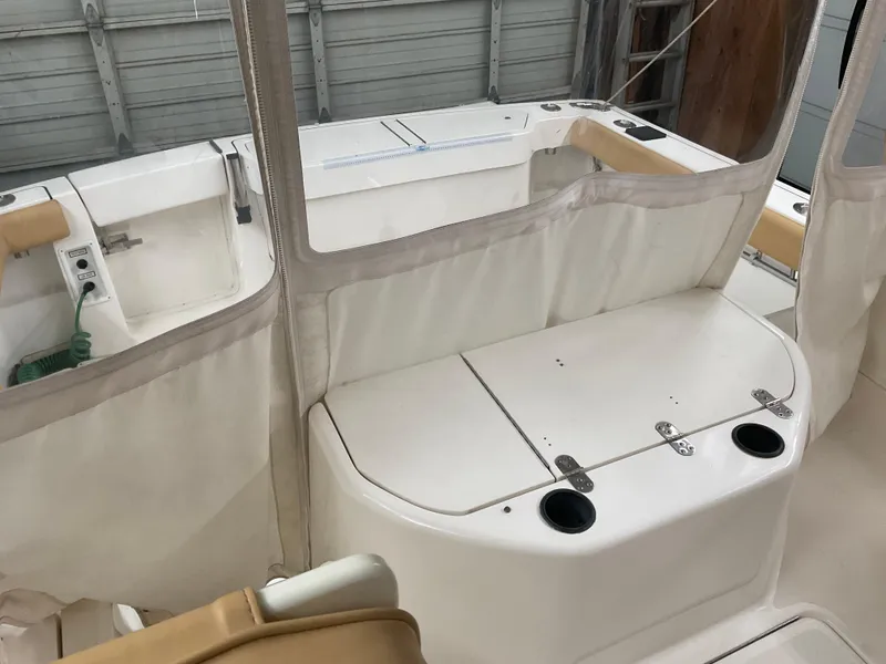 Slide: The Image of 1999 Pursuit Offshore Express boat interior with seating and storage compartments. - 34