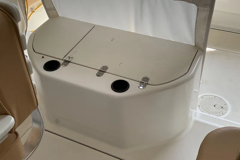 Slide: The Image of 1999 Pursuit OFFSHORE EXPRESS boat interior with storage compartment and cup holders. - 35