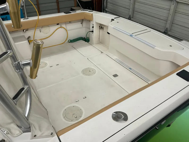 Slide: The Image of 1999 Pursuit Offshore Express boat interior with spacious deck and fishing rod holders. - 39