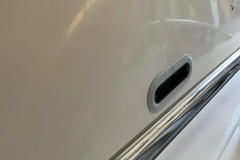 Slide: The Image of Close-up of 1999 Pursuit OFFSHORE EXPRESS boat hull with chrome detailing. - 41